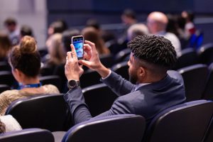 audience member taking phone photo